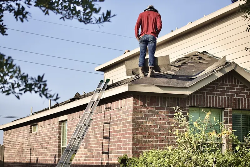 Professional roofer working on a residential roof in Robeson